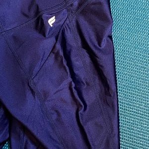 Woman’s Fabletics shiny blue pocketed leggings
